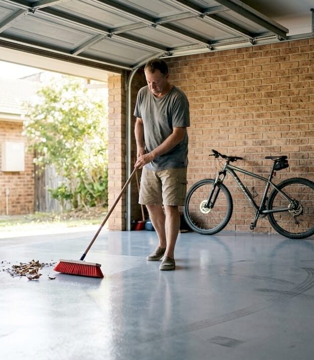 1774504037936_Homeowner-sweeping-clean-epoxy-garage-floor Homeowner sweeping clean epoxy garage floor