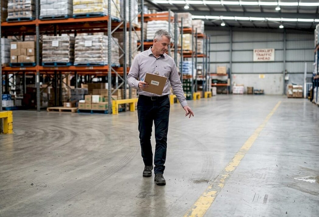 Facility manager inspecting industrial floor