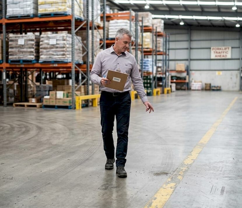 Facility manager inspecting industrial floor