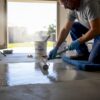 Installer applying epoxy to residential garage floor